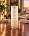 LEVIESA The Relief Cream, 1 oz airless pump bottle with menthol 5% and camphor 5%, standing on a wooden table